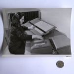 Photo of woman at desk with pegboard and Comptometer 992