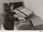Photo of woman at desk with pegboard and Comptometer 992