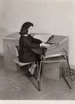 Photo of woman at desk with Comptometer 992 on side table